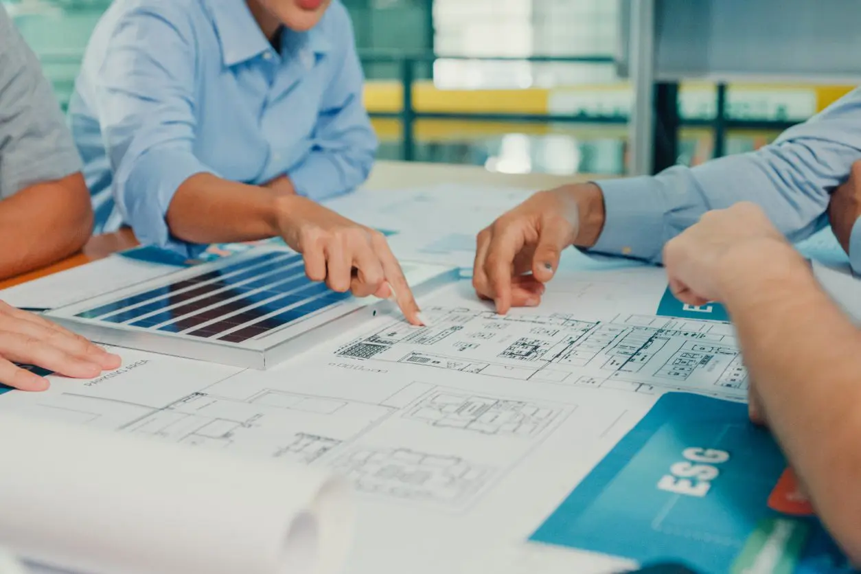 People discussing architectural plans and samples.