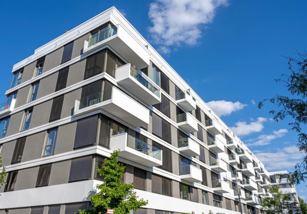 Modern apartment building under blue sky.